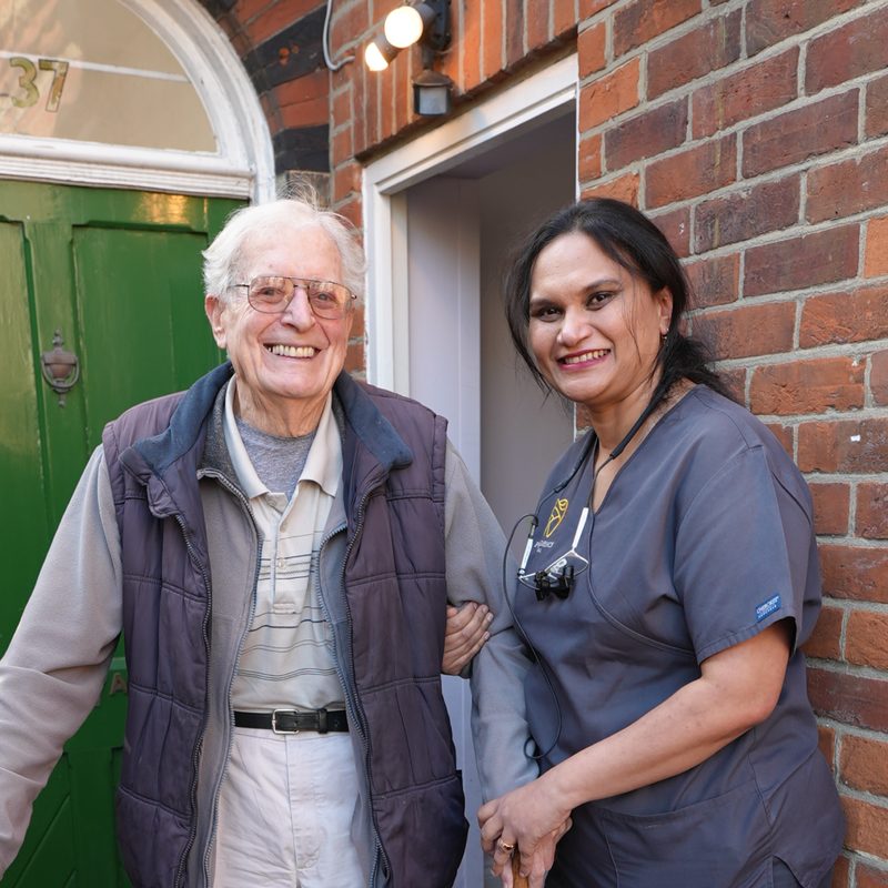 A happy patient with a Providence Dental clinician outside the practice